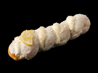 Donut-pigtail in white glaze on a black background