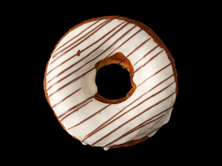 Biscuit donut with white icing on a black background