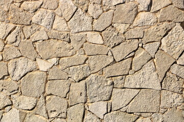 Old yellow brown masonry wall of stones