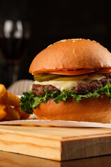 Burger on the board. vertical photo.