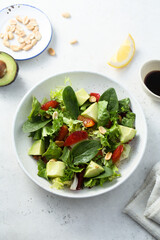 Healthy green salad with avocado and bloody orange