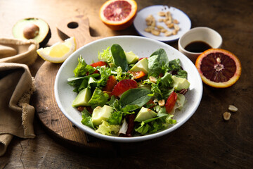 Healthy green salad with avocado and bloody orange
