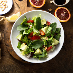 Healthy green salad with avocado and bloody orange