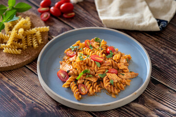 Fusilli pasta stir fired with tomato sauce and chicken, homemade Italian food