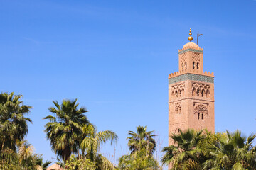 Fototapeta na wymiar Minaret of Koutoubia mosque on blue sky background in Marrakech, Morocco