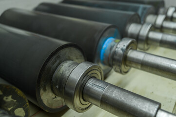 Used printing shafts for flexographic printing press. A set of rubberized knurling shafts in a...