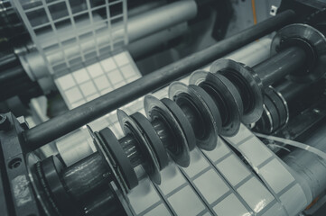 Rotating knives for cutting a self-adhesive label into several narrow ribbons. Equipment for the...