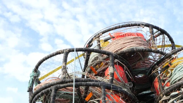 Traps, ropes and cages on pier, commercial dock, fishing industry, Monterey California USA. Empty pots, creels for fish seafood catching in port. Many fisherman's nets and baskets in seaport. Fishery.