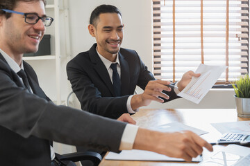 financial advisory services. Asian advisor showing plan of investment to clients in the consultancy office.