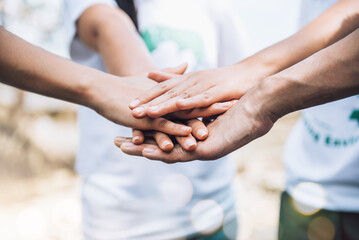 Close up of people volunteer teamwork putting hands together,Stack of hands,Unity and teamwork on world environment day.