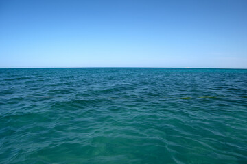 Closeup seascape surface of blue sea water with small ripple waves