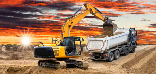excavator is digging on construction site - obrazy, fototapety, plakaty