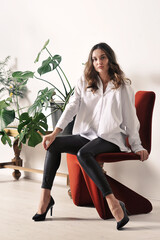 beautiful girl in a white shirt is sitting