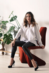 beautiful girl in a white shirt is sitting