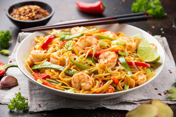 Stir fry noodles with prawns and vegetables in white plate. Healthy asian food