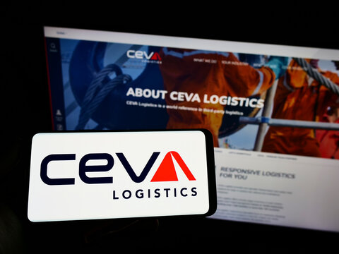 Stuttgart, Germany - 03-12-2022: Person holding smartphone with logo of French freight company CEVA Logistics on screen in front of website. Focus on phone display.