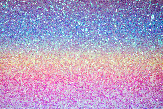 Pink purple and blue glitter texture, shiny sequins abstract background with blur. Party baby blur glitter texture background
