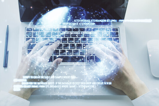 Double exposure of abstract programming language hologram with world map and hands typing on laptop on background, research and development concept