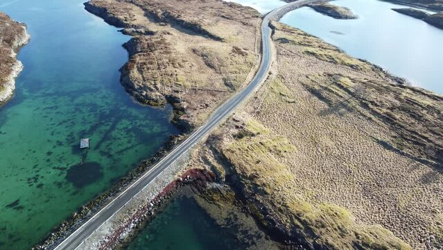 narrow car road connecting many small islands together on the island of heroy in nordland