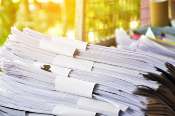 Used white paper is bundled together in piles infront of the bulcony to be sold or made into recycled paper for future use. Soft and selective focus, global warming concept.