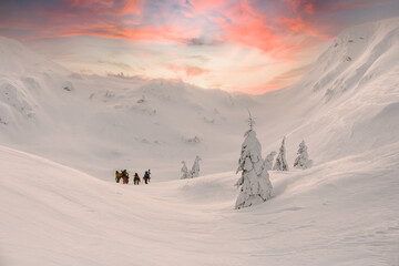 beautiful view of the winter landscape of snow-capped mountains and group of tourists on it