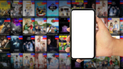 hand holding phone with blank screen on blur streaming television background 