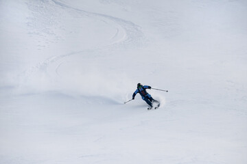 Naklejka na ściany i meble view on snowboarder riding down the untouched powder snow.