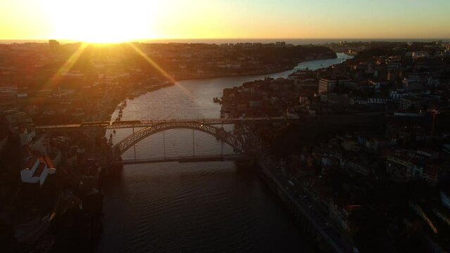 A drone view of the sunset on the Duero River in Porto, Portugal.