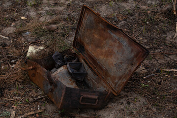 Burnt metal military box on the ground