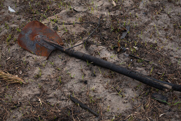 Burnt shovel lies on the ground
