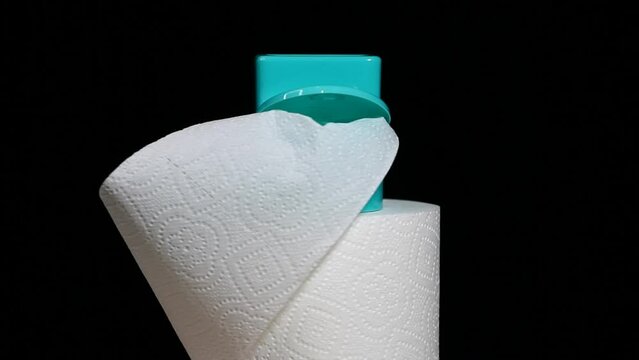 footage of miniature toilet paper dark background 