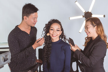 A young pretty Filipino actress or celebrity idol with her makeup artist and stylist backstage at...