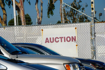 Car auction sign on fence