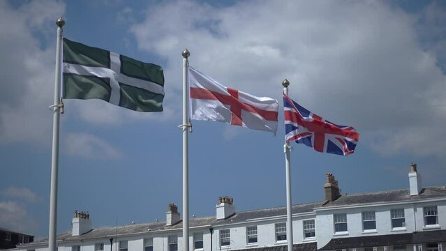 The flags of Devon, England and the UK flying together.