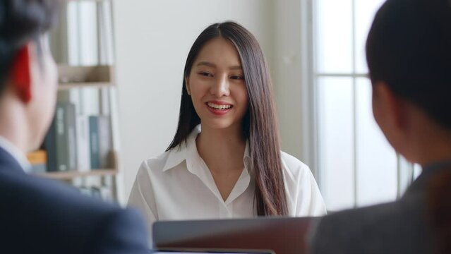 Young Asian woman talking with manager team for job interview in office