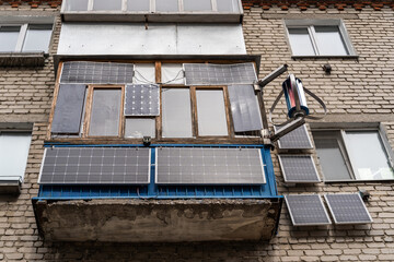 Green energy from solar panels on the balcony and wall in a multi-storey building gives free electricity to a separate apartment and save money.