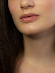 Fototapeta premium Perfect natural lip makeup. Close up macro photo with beautiful female mouth. Plump full lips. Close-up face detail. Perfect clean skin, light fresh lip make-up. Beautiful spa tender lip