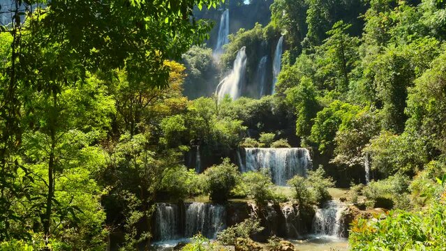 Fairy waterfall at wild forest Thi Lo Su Waterfall or Thee Lor Sue in Thailand. Forest waterfall in beautiful tropical jungle in Tak province. Magical scenic view of largest Thai falling waterfall