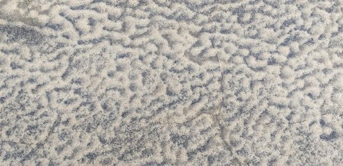 abstract winter background: frost patterns on the ground