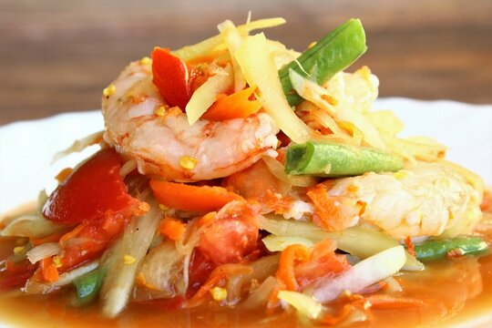 Close up papaya salad with fresh shrimps or som tam Thai food photo