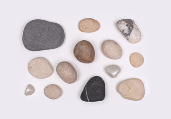 Stones on neutral gray copy space background. Flat lay, top view.