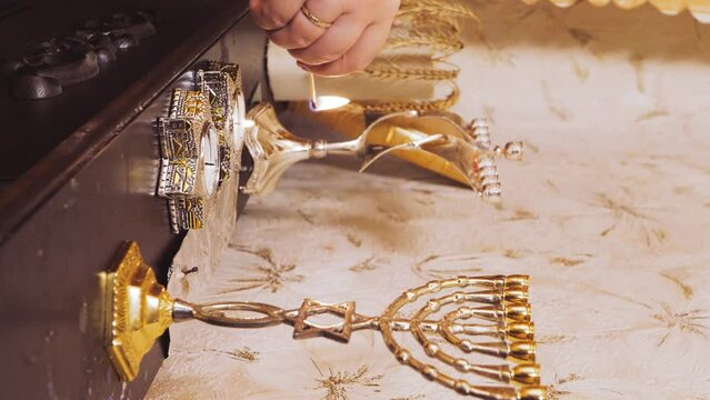 A Jewish woman lights candles on the eve of Pesach, which coincides with Saturday. vertical video