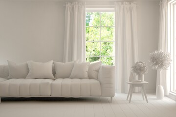 Fototapeta premium Mock up of stylish room in white color with sofa and green landscape in window. Scandinavian interior design. 3D illustration