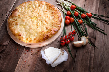 Ossetian pie with cheese and herbs on the table