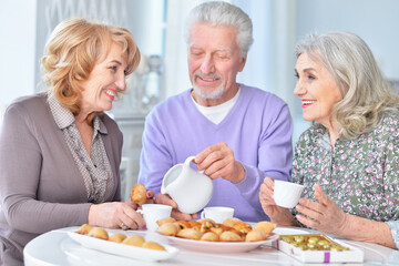 Portrait of happy senior people drinking tea