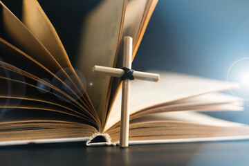Homemade cross on an open Holy Bible book. Cross in open Bible.