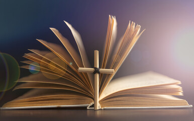 Homemade cross on an open Holy Bible book. Cross in open Bible.
