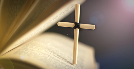 Homemade cross on an open Holy Bible book. Cross in open Bible.