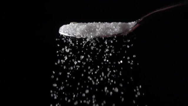 pouring sugar from a spoon, slow motion 10x