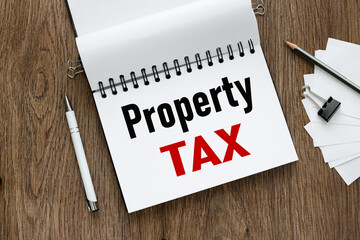 PROPERTY TAX open notepad with text near white stickers